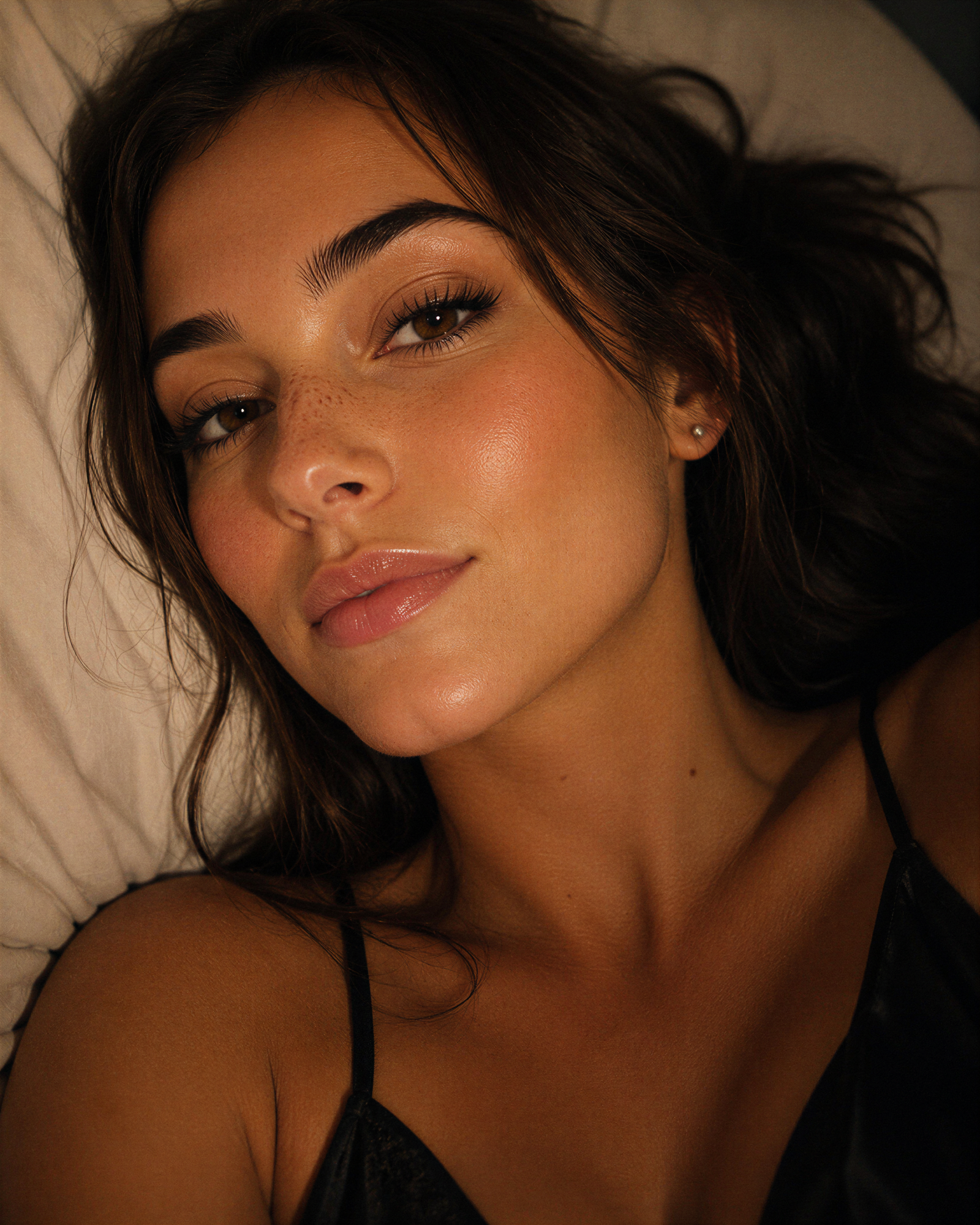 Close-up portrait of Elle Graci resting on a pillow.